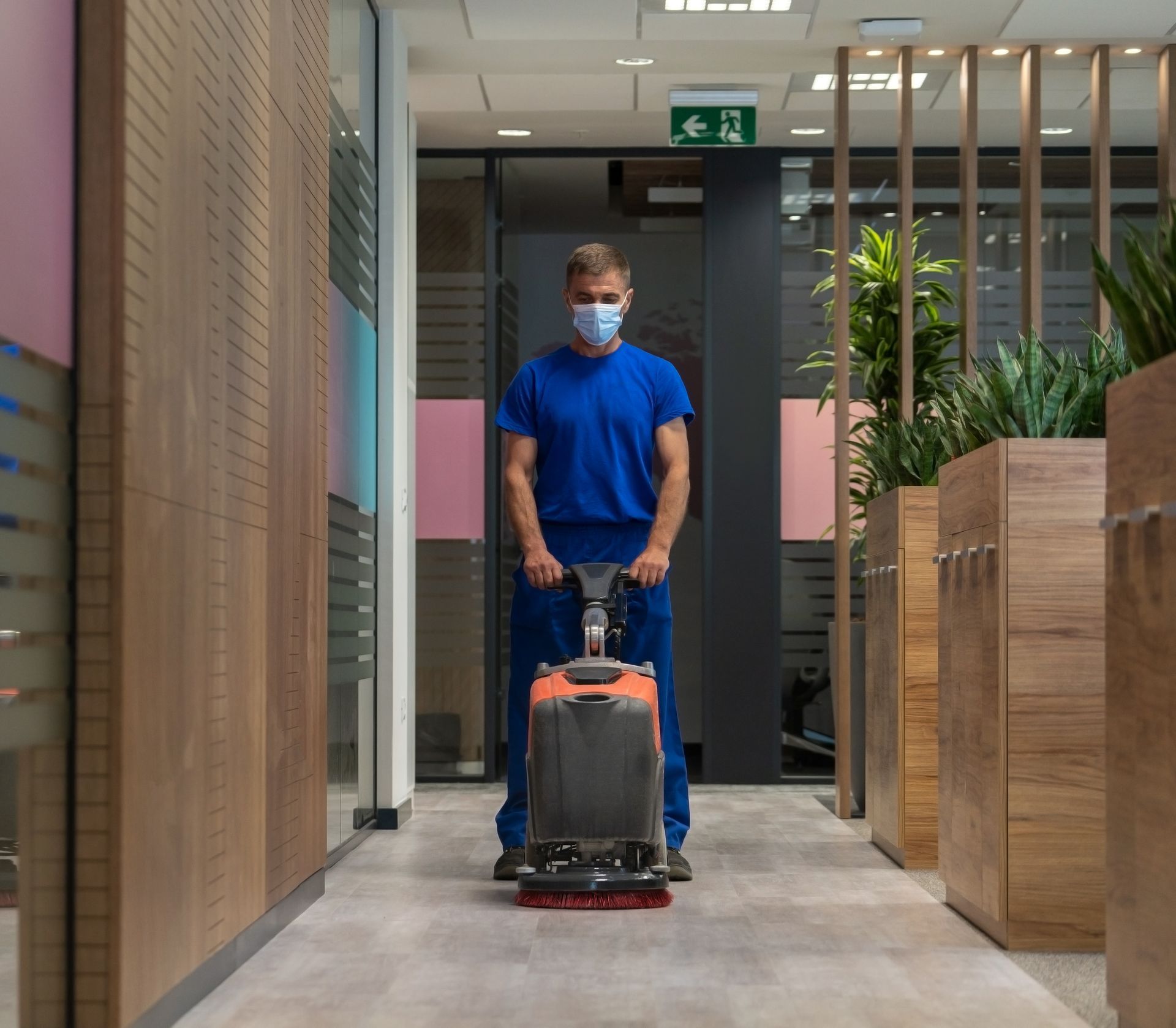 Using a machine to clean a hallway.