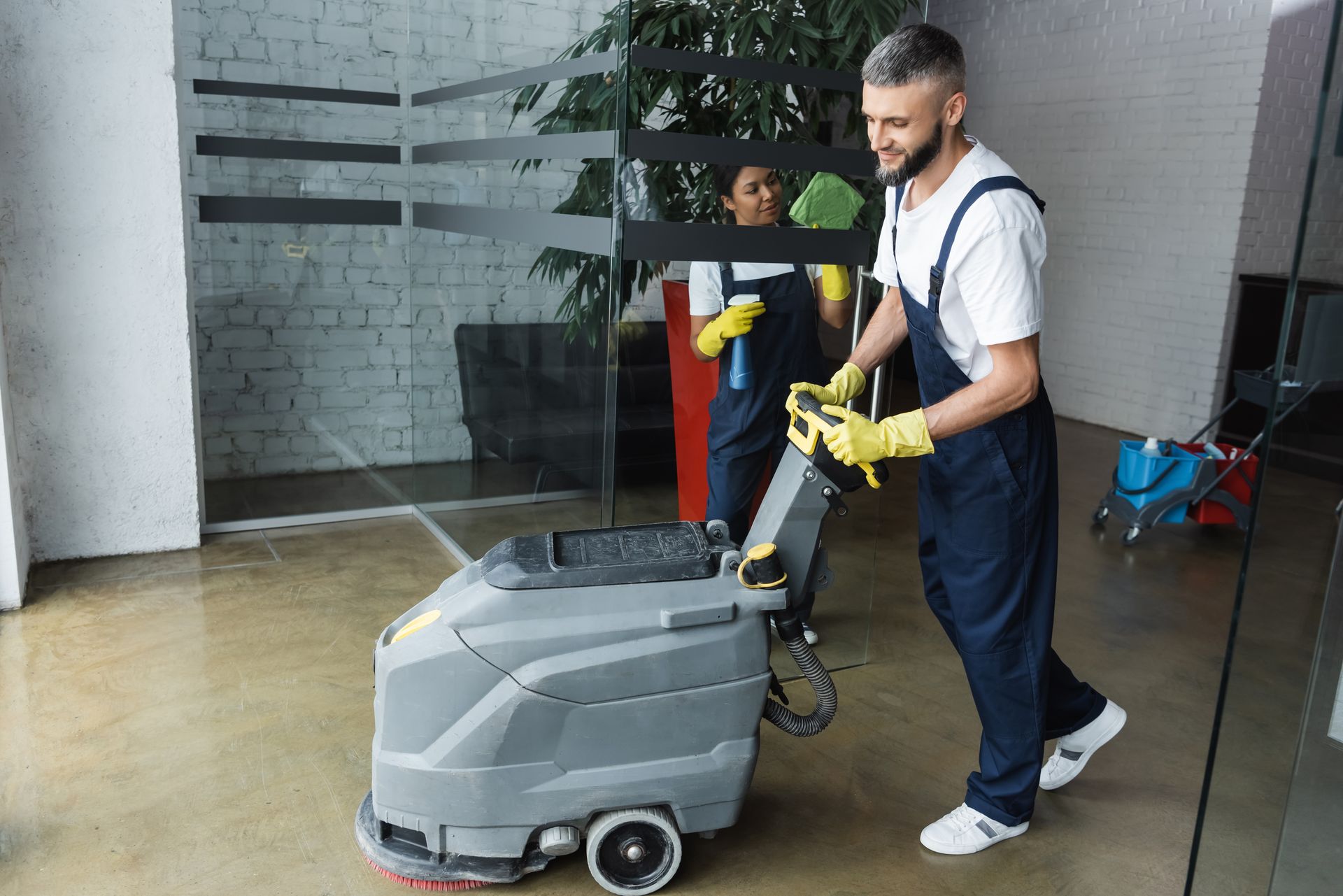 Cleaning the floor with a machine.