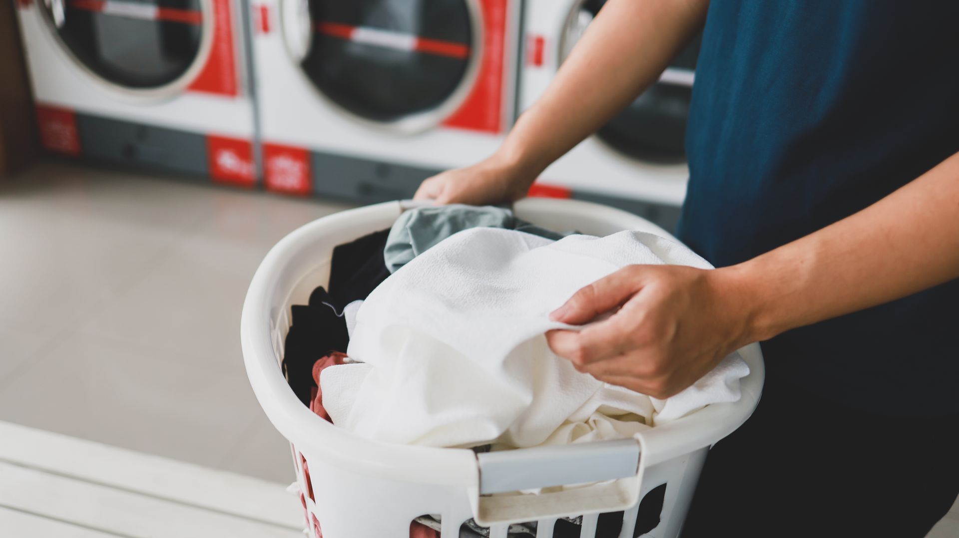 A person is holding a laundry.