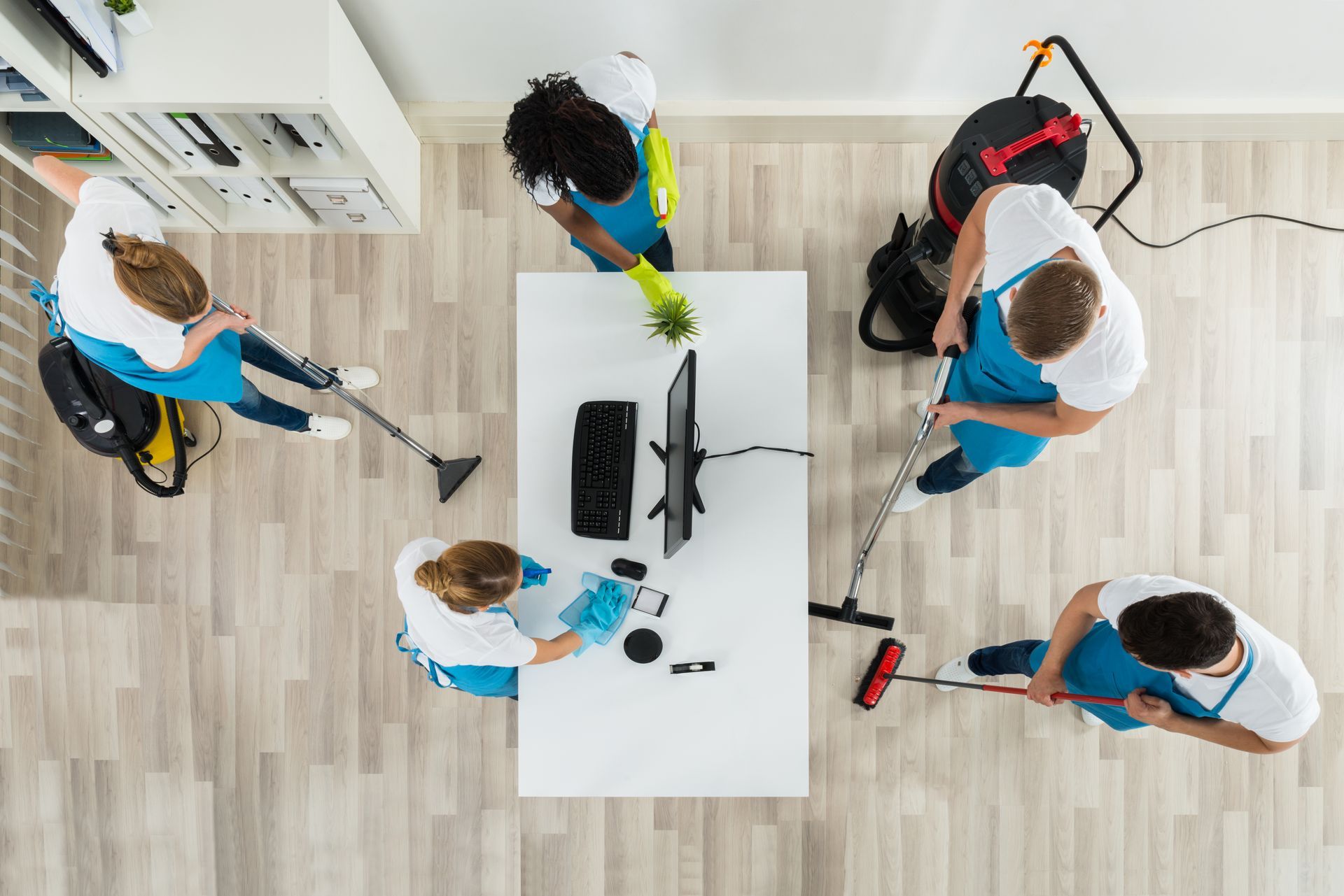 Cleaners are cleaning an office.