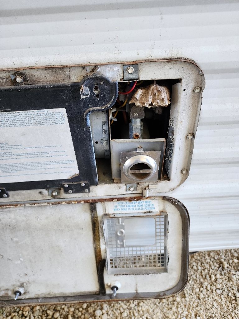 The inside of a camper with the door open.