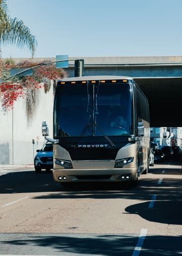 charter bus driving through San Diego for organized group travel