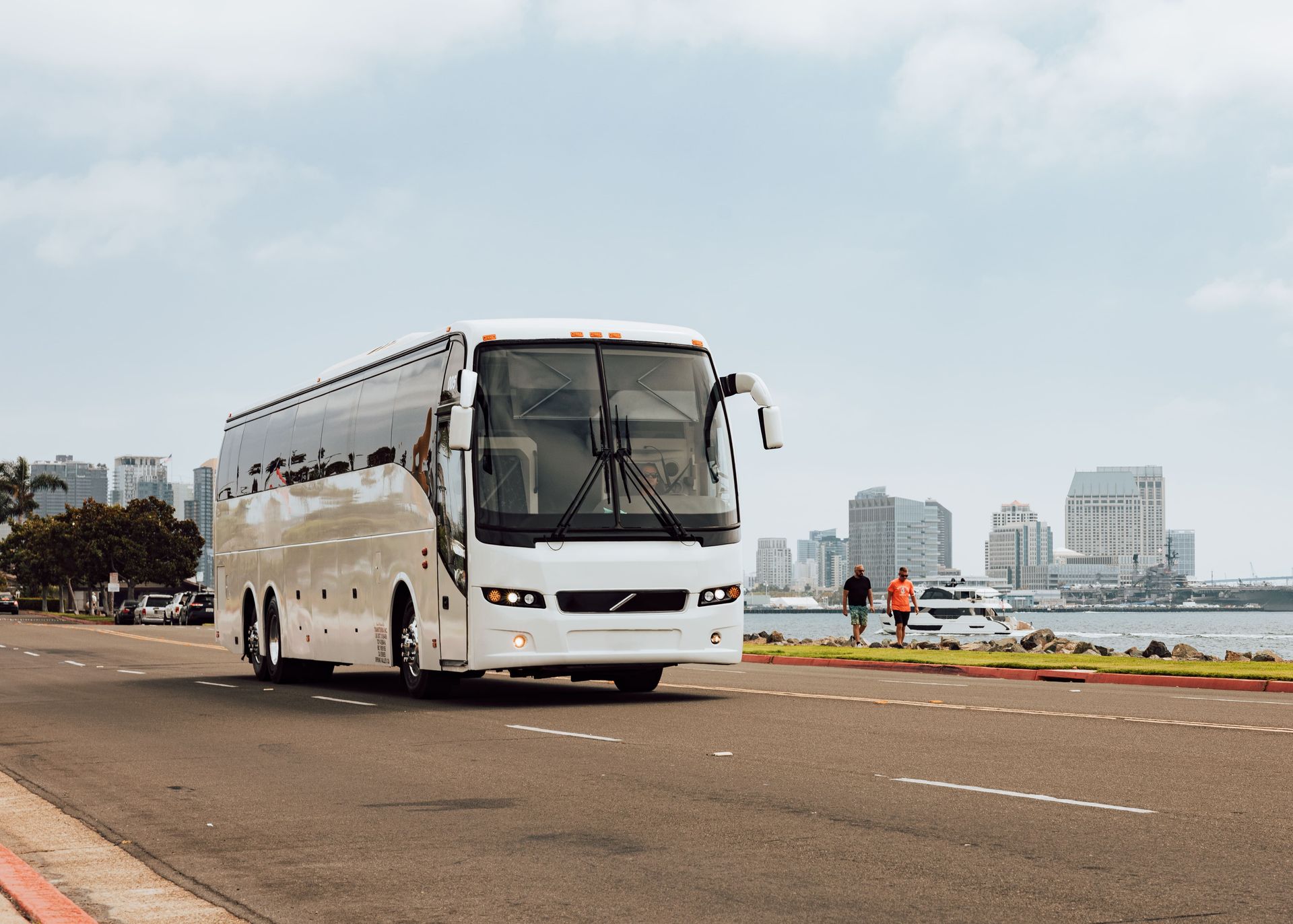 Bus rental San Diego group boarding at coastal viewpoint