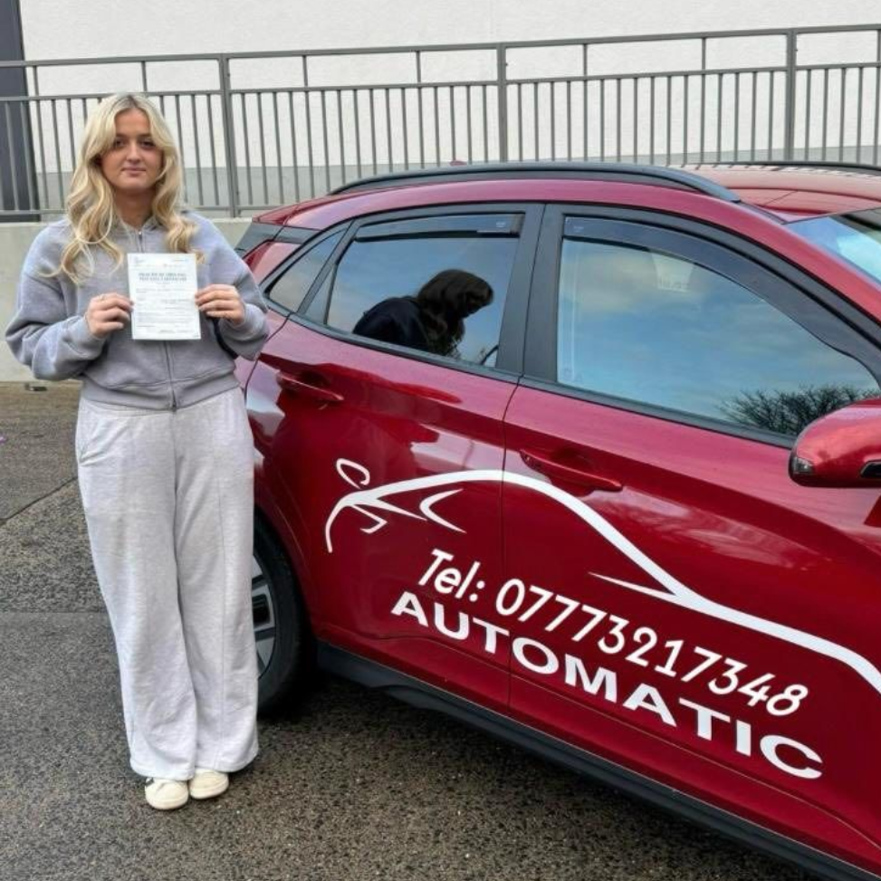 Woman holding a sign beside a red automatic car with phone number on the door.