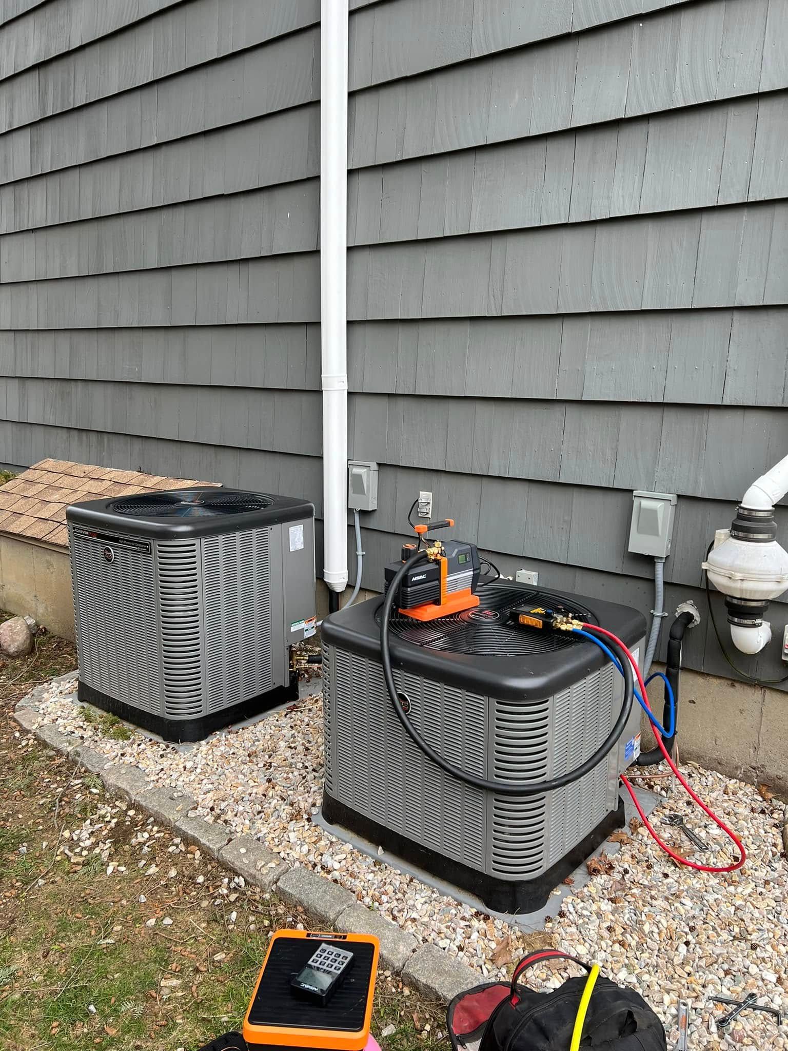 A pile of copper and silver rings on a black surface
