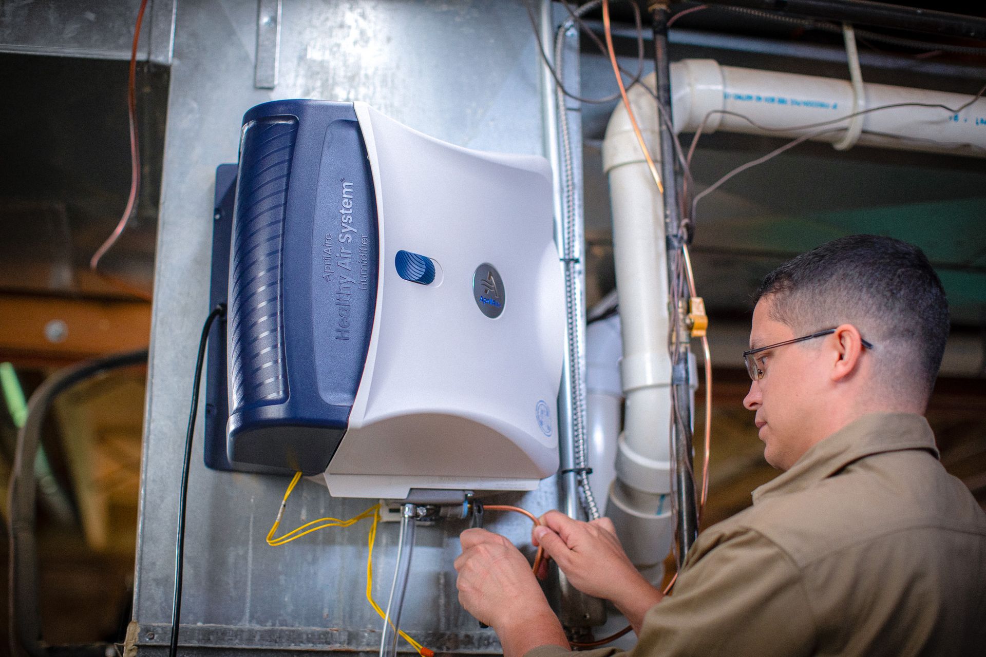 A bunch of silver beads are sitting on top of each other on a blue surface.