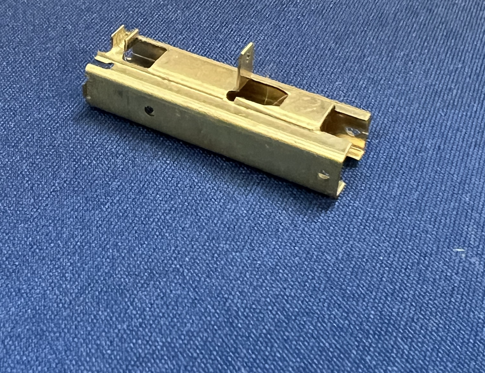 A small piece of metal is sitting on top of a blue cloth.