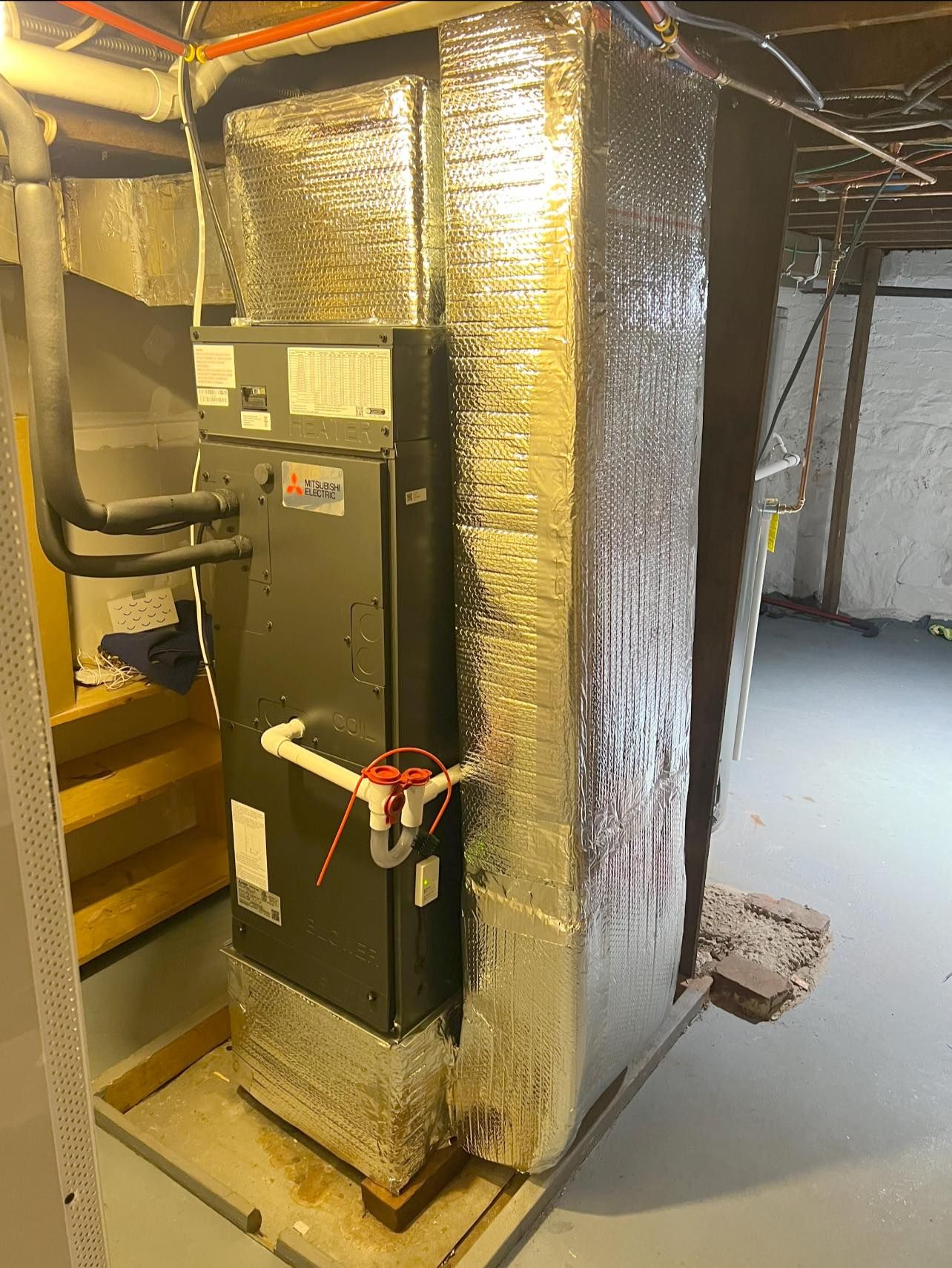 A bunch of silver beads are sitting on top of each other on a blue surface.