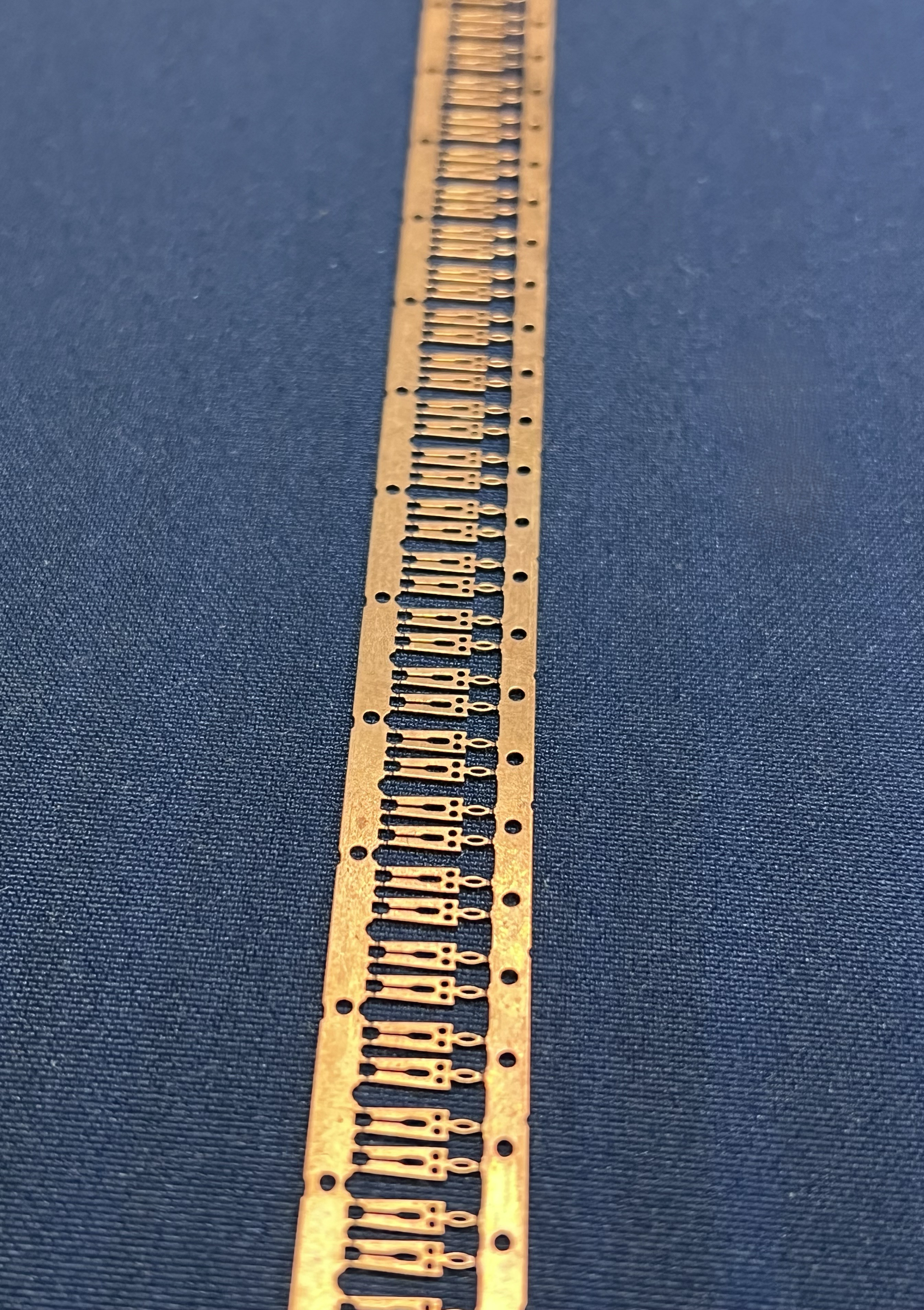 A close up of a metal strip with holes in it