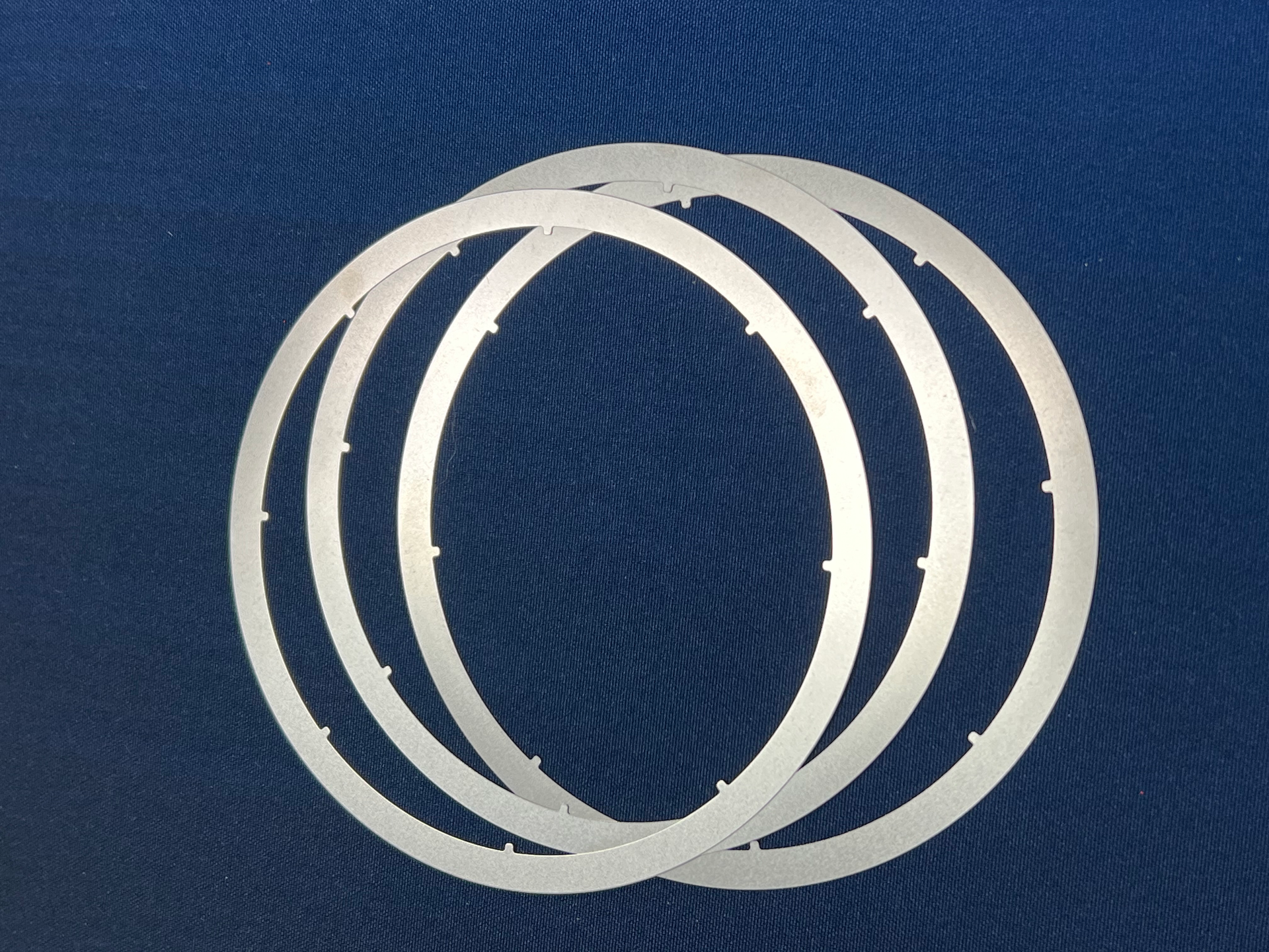 A pair of silver rings on a blue background