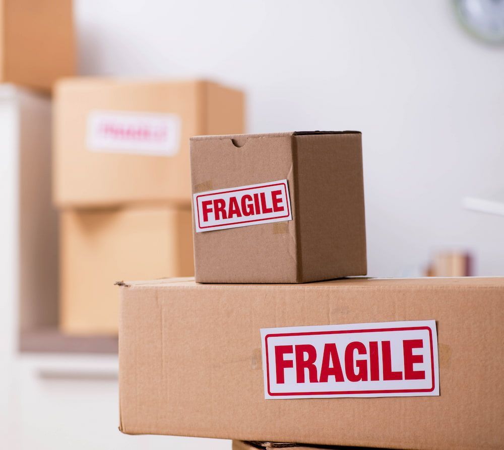 A Cardboard Box With a Fragile Sticker on It — Express Couriers Mackay in Nebo, QLD