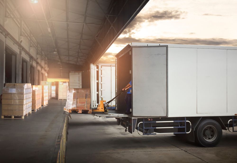 A White Truck is Parked in a Warehouse With Its Doors Open — Express Couriers Mackay in West Mackay, QLD