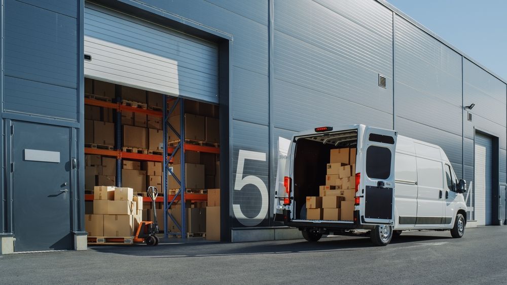 A Delivery Van is Parked in Front of a Warehouse — Express Couriers Mackay in Paget, QLD