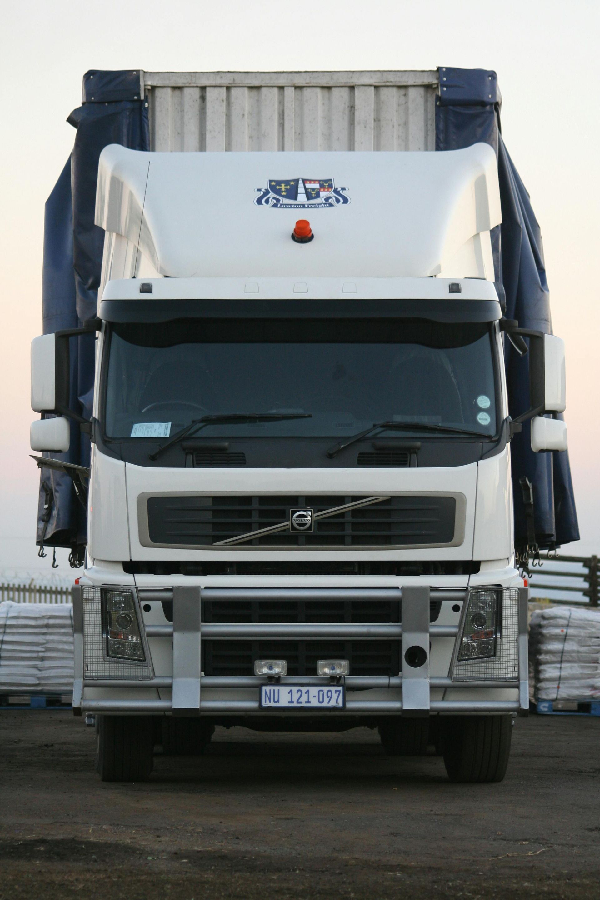 A White Delivery Van is Driving Down a City Street — Express Couriers Mackay in West Mackay, QLD