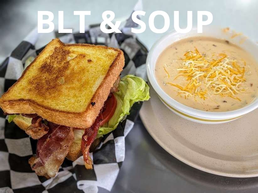 A blt sandwich next to a bowl of soup