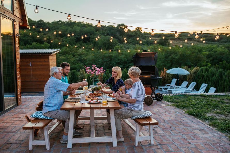 A group of people are sitting at a table eating food.