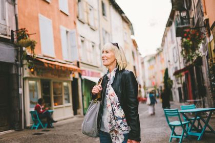 A woman is walking down a city street.