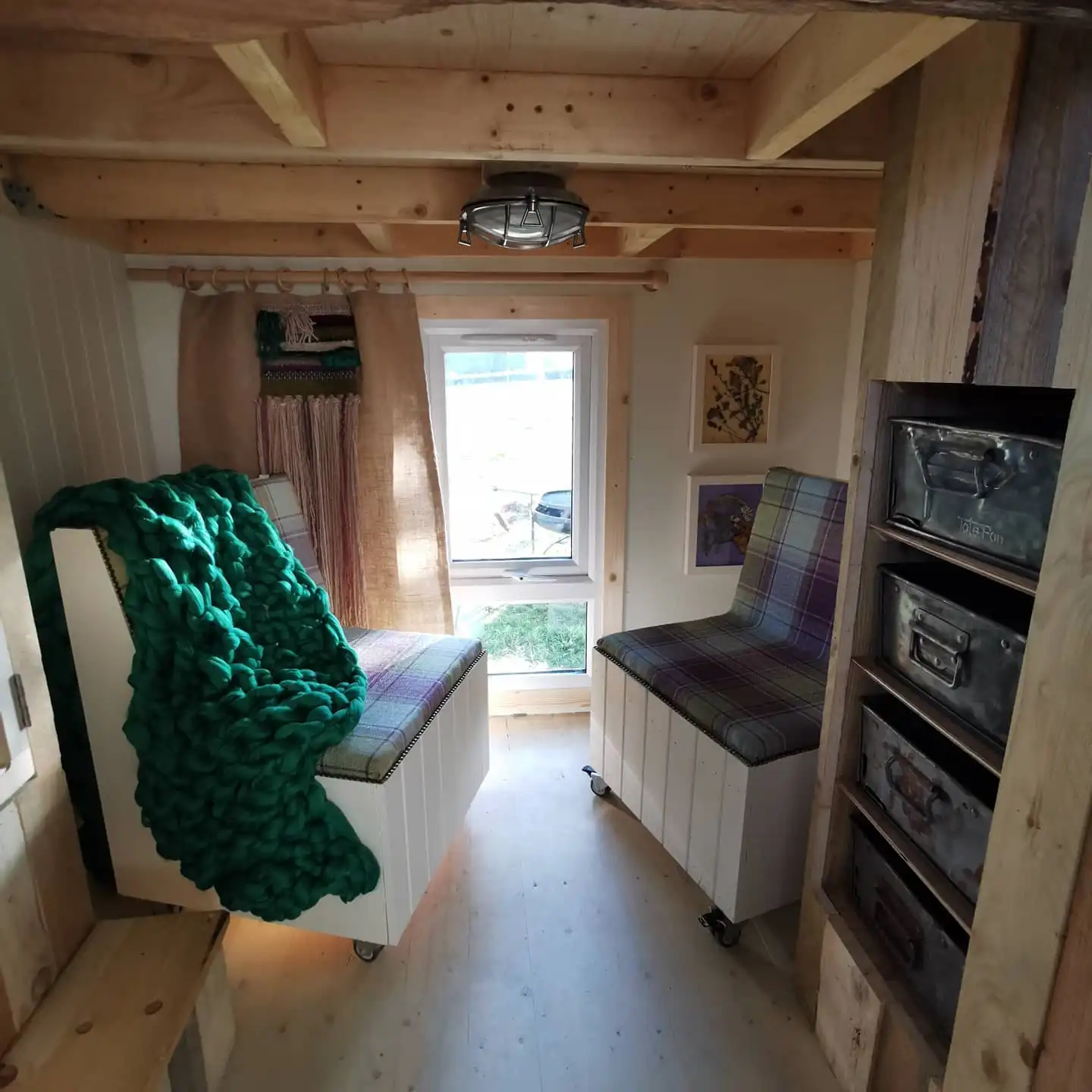 A room with a green blanket on a chair