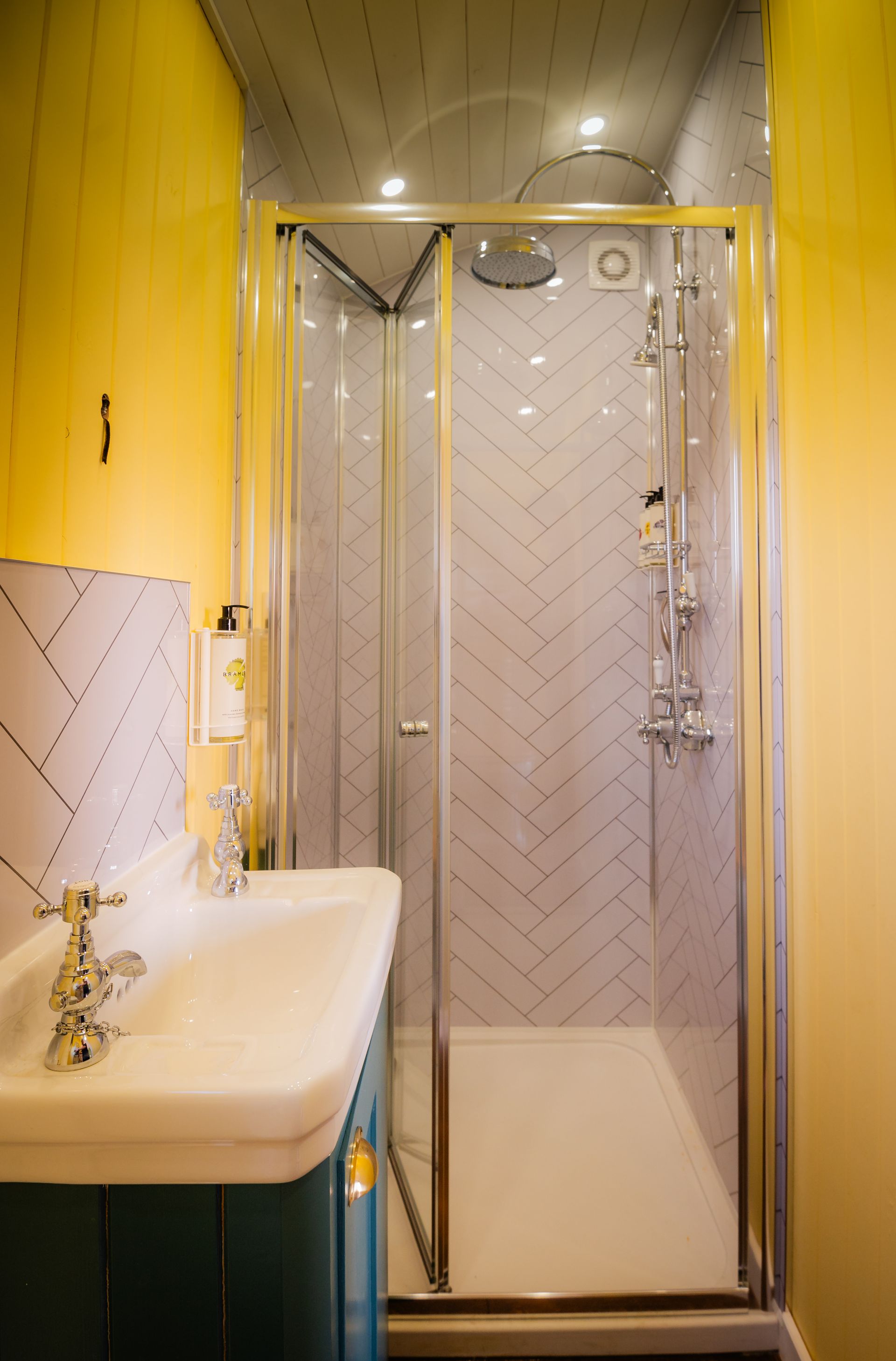 A bathroom with a sink and a walk in shower.
