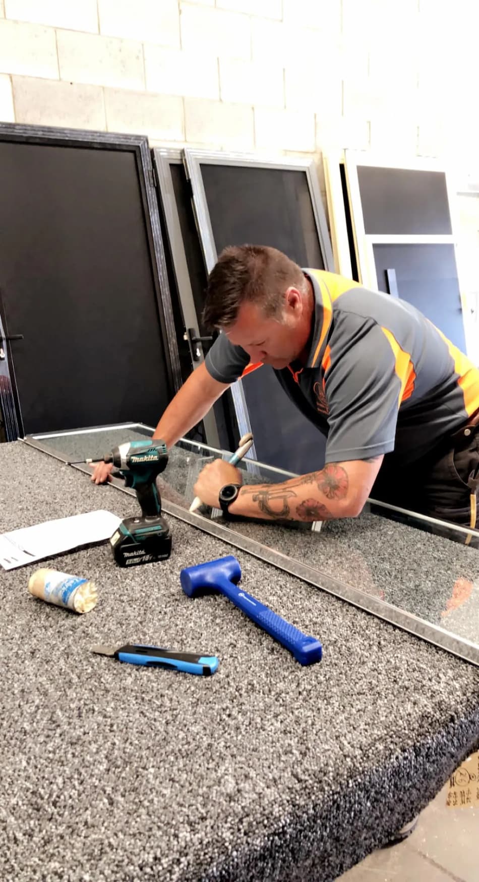 Man Cutting Glass Panel to Size — Glaziers in Dubbo, NSW