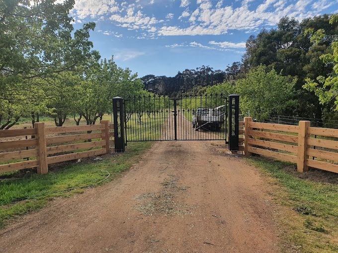 A white lattice fence is in front of a brick house.