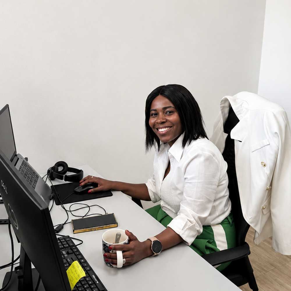Smiling Quintrip travel consultant at her desk