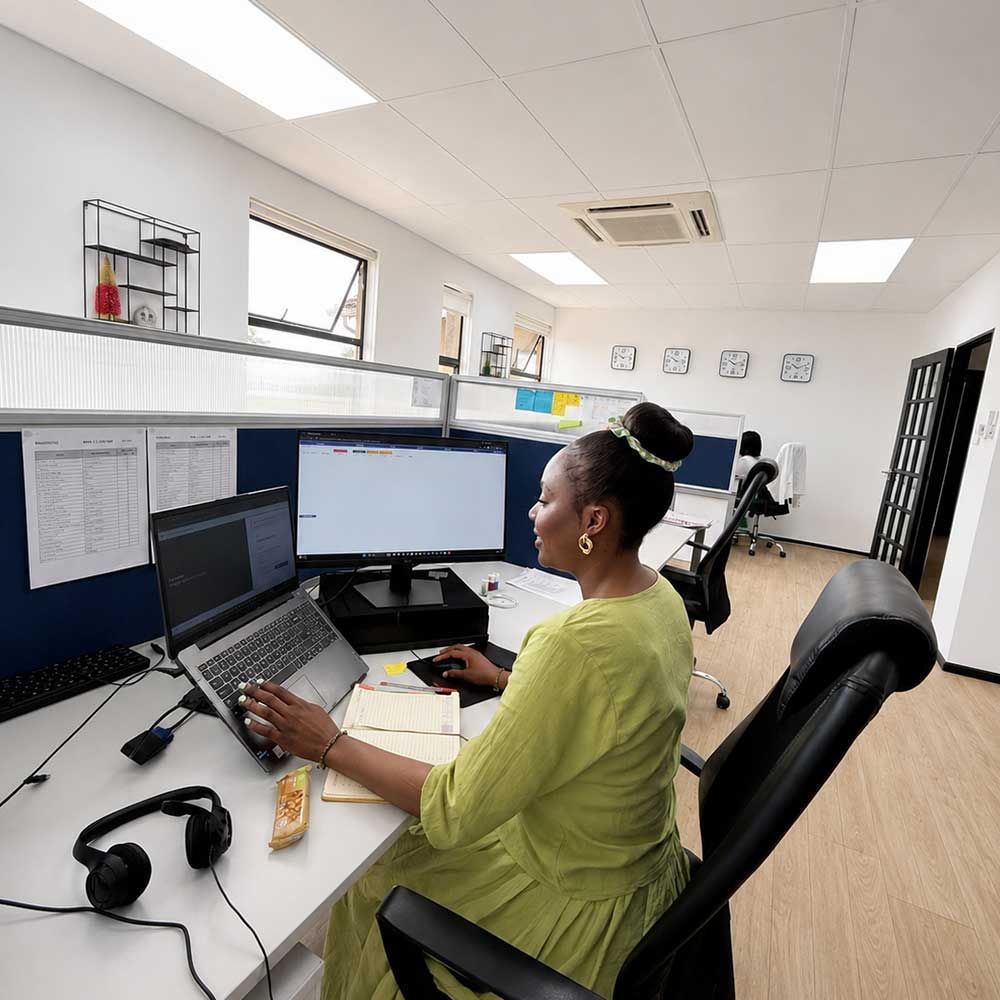 Quintrip consultant working at a computer in the open-plan office