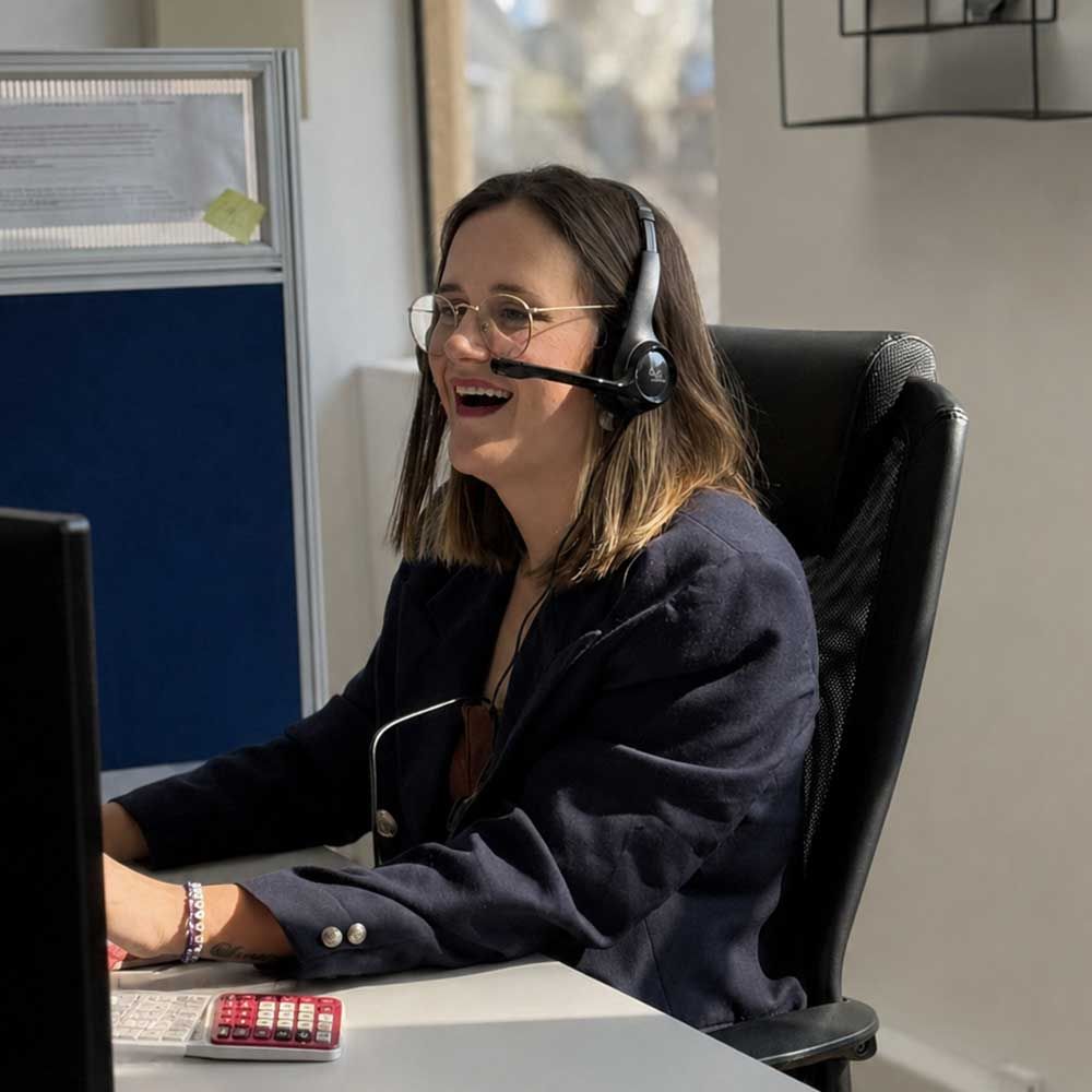 Quintrip consultant on a call with a headset