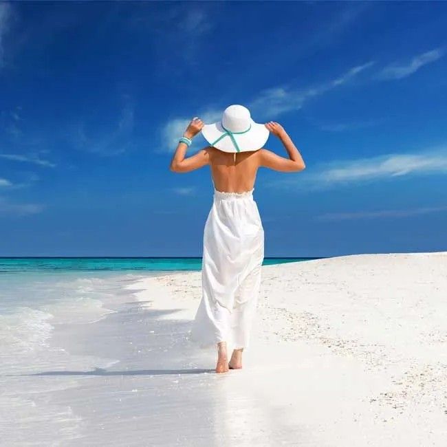 Woman walking along a beach