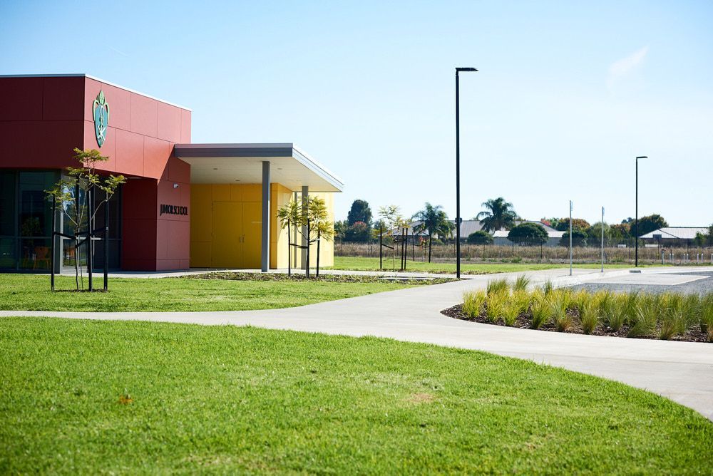 A Modern Building With a Red and Yellow Facade — Quarrell Civil Construction In Congupna, VIC