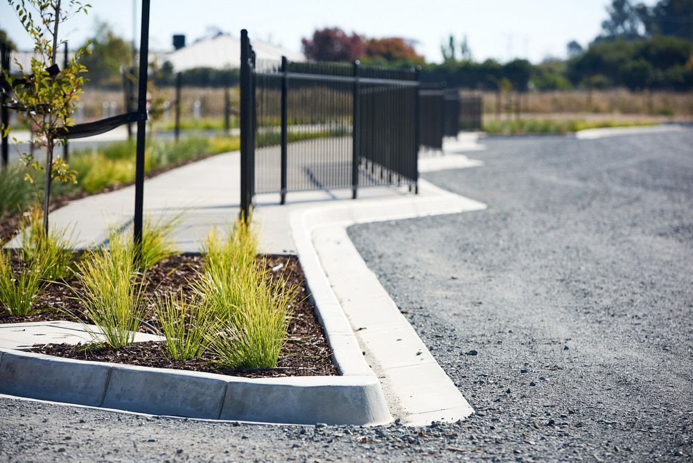 A Paved Walkway With a Black Metal Fence — Quarrell Civil Construction In Congupna, VIC