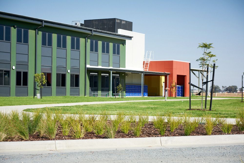 A Green and Orange Modern School Building — Quarrell Civil Construction In Congupna, VIC