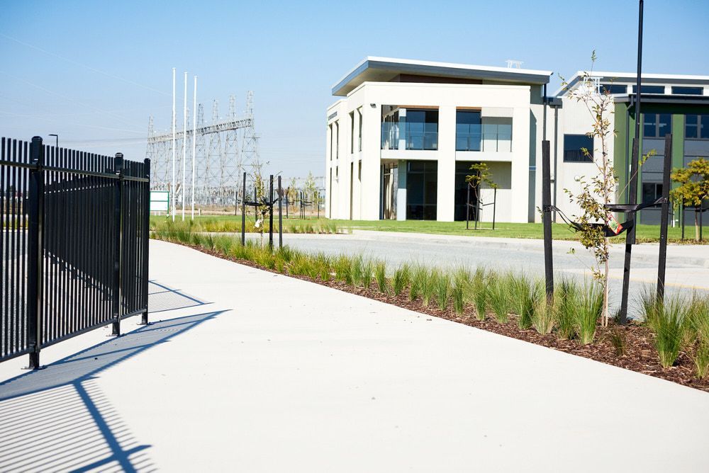 A Paved Path Leads Toward a Two-story Modern Building — Quarrell Civil Construction In Congupna, VIC