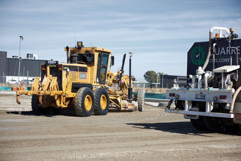 A Yellow Motor Grader Parks on a Construction Site — Quarrell Civil Construction In Congupna, VIC
