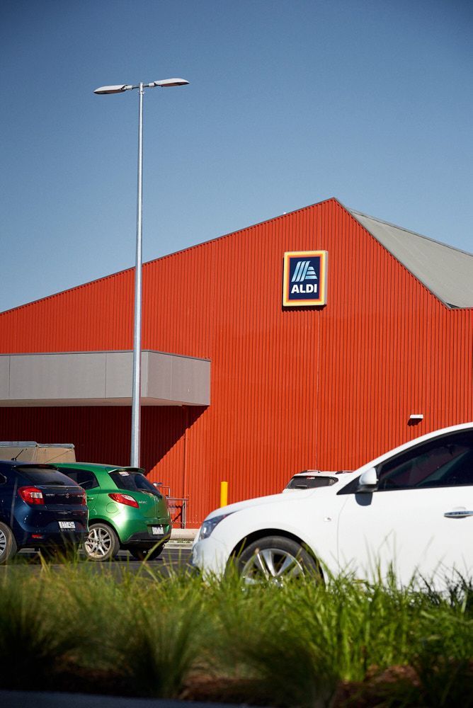 An Aldi Grocery Store With a Bright Red Metal Exterior — Quarrell Civil Construction In Congupna, VIC