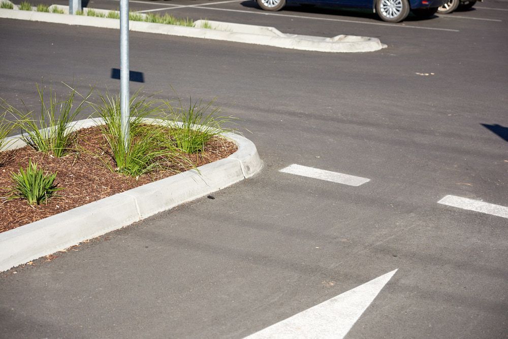 A Paved Parking Lot With a Concrete Curb, Landscaped Planter Bed — Quarrell Civil Construction In Congupna, VIC