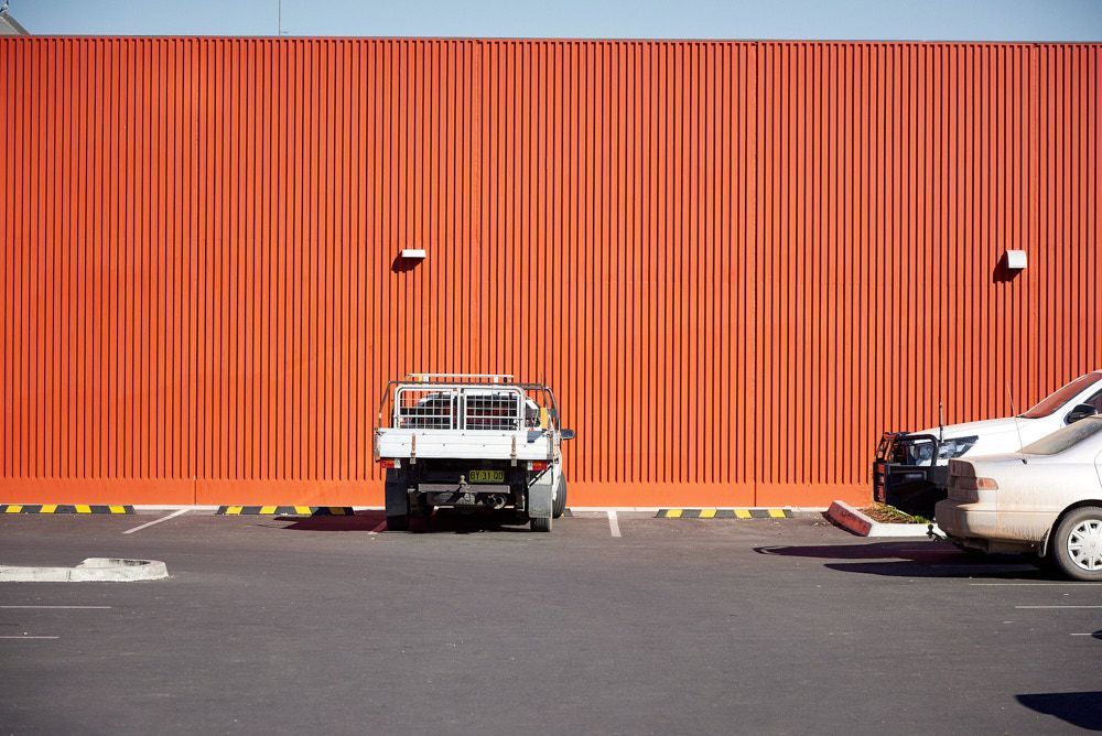 A White Ute With a Metal Cage Tray Parked in Front of a Tall — Quarrell Civil Construction In Congupna, VIC