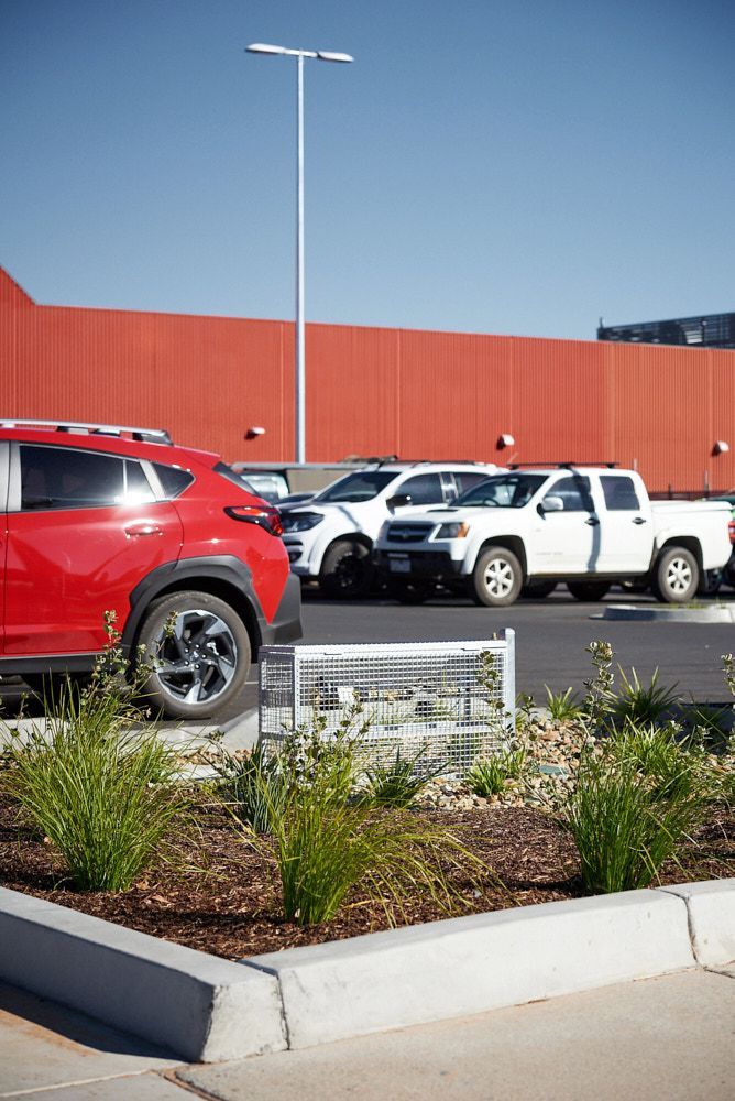 A Red Suv and White Pickup Trucks Parked in a Sunny Lot — Quarrell Civil Construction In Congupna, VIC