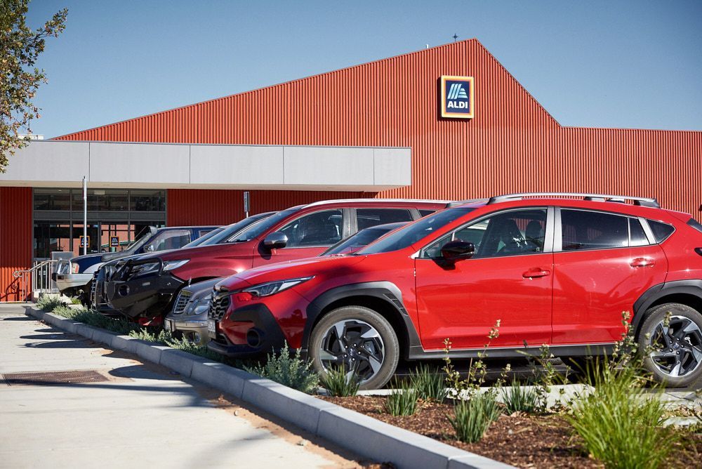 A Bright Red Suv Parked in Front of an Aldi Store With a Distinctive — Quarrell Civil Construction In Congupna, VIC