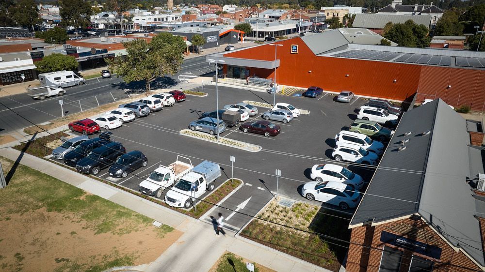 Aerial View of an Outdoor Parking Lot With Numerous Cars Parked — Quarrell Civil Construction In Congupna, VIC
