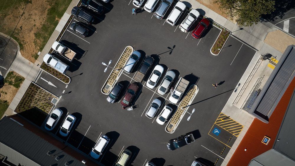An Aerial View of a Paved Parking Lot Containing Various Cars — Quarrell Civil Construction In Congupna, VIC