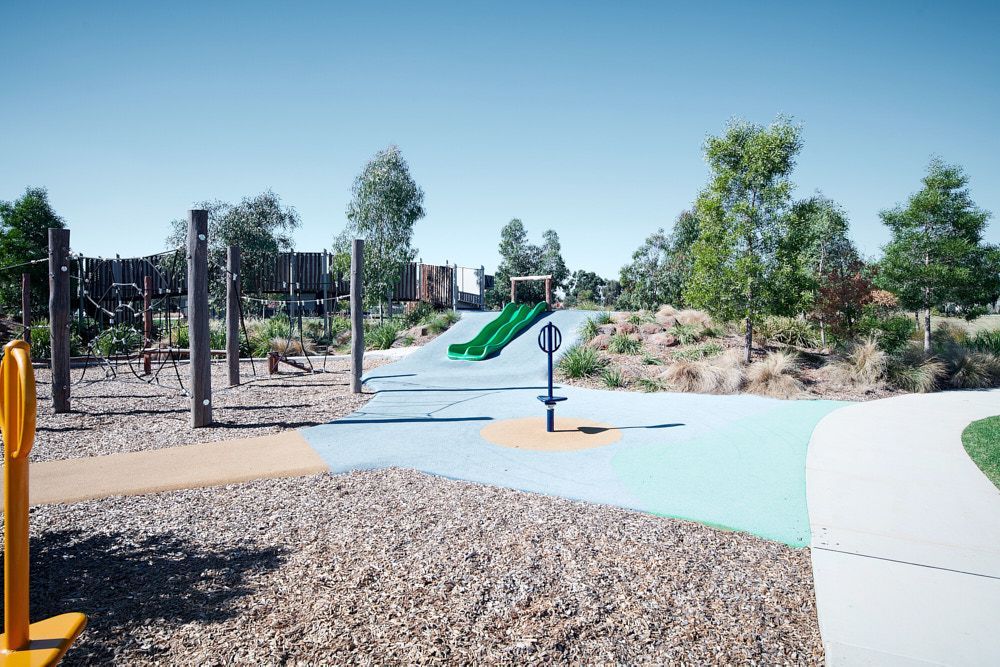 A Sunny Outdoor Playground With a Green Slide — Quarrell Civil Construction In Congupna, VIC