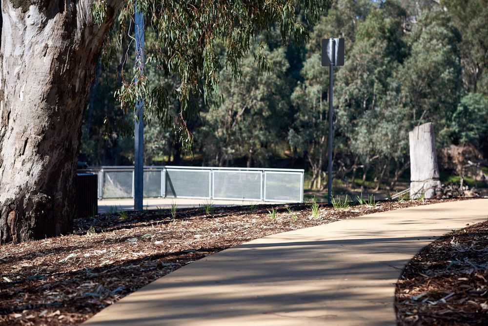 A Paved Path Curves Through a Park With a Large Tree on the Left — Quarrell Civil Construction In Congupna, VIC