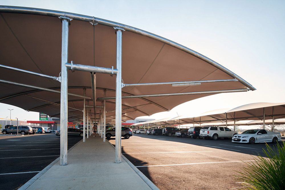 Parking Lot With Vehicles Under Large Tan Shade Structures — Quarrell Civil Construction In Congupna, VIC