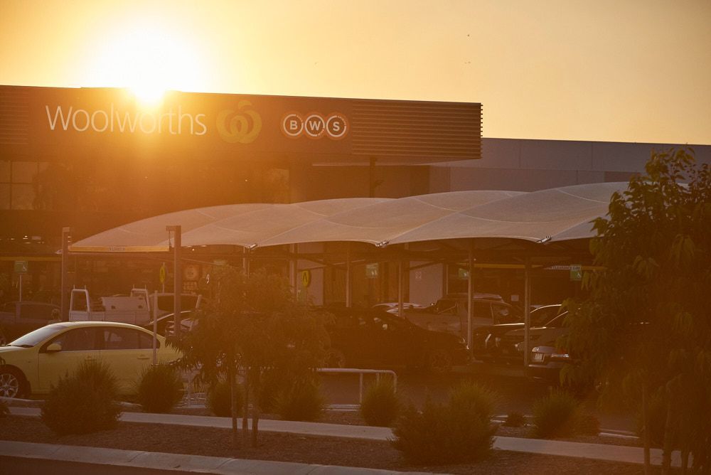 A Woolworths Supermarket Storefront and Parking Lot Under a Bright — Quarrell Civil Construction In Congupna, VIC