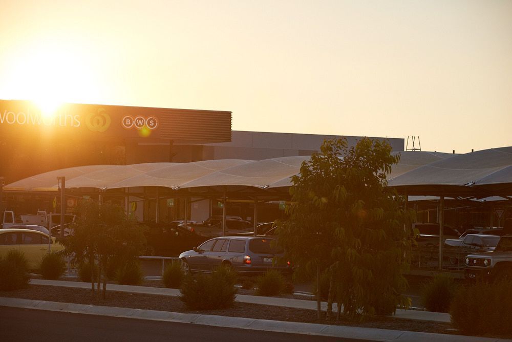 A Sunlit Parking Lot Featuring Multiple Fabric Shade Structures Over Vehicles — Quarrell Civil Construction In Congupna, VIC