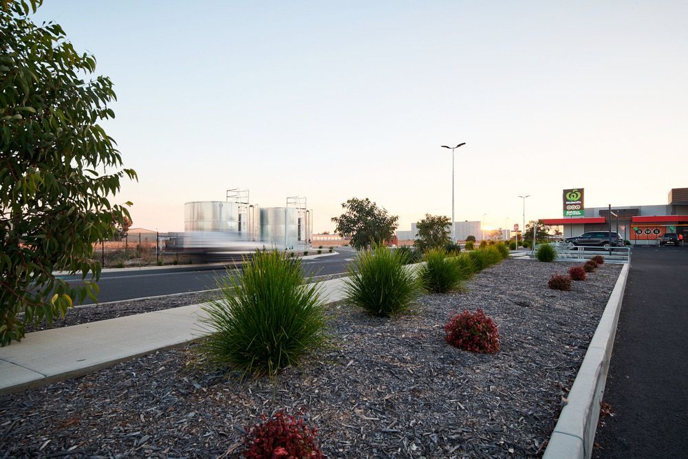 A Gravel Landscaping Strip With Green Grasses — Quarrell Civil Construction In Congupna, VIC
