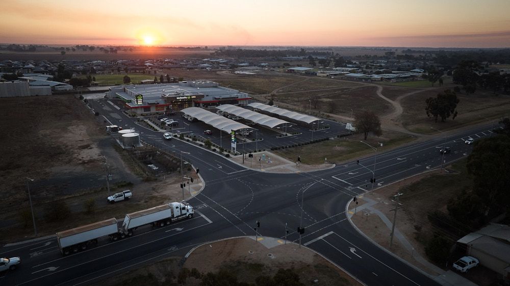 An Aerial View at Sunset of a Commercial Shopping Center — Quarrell Civil Construction In Congupna, VIC