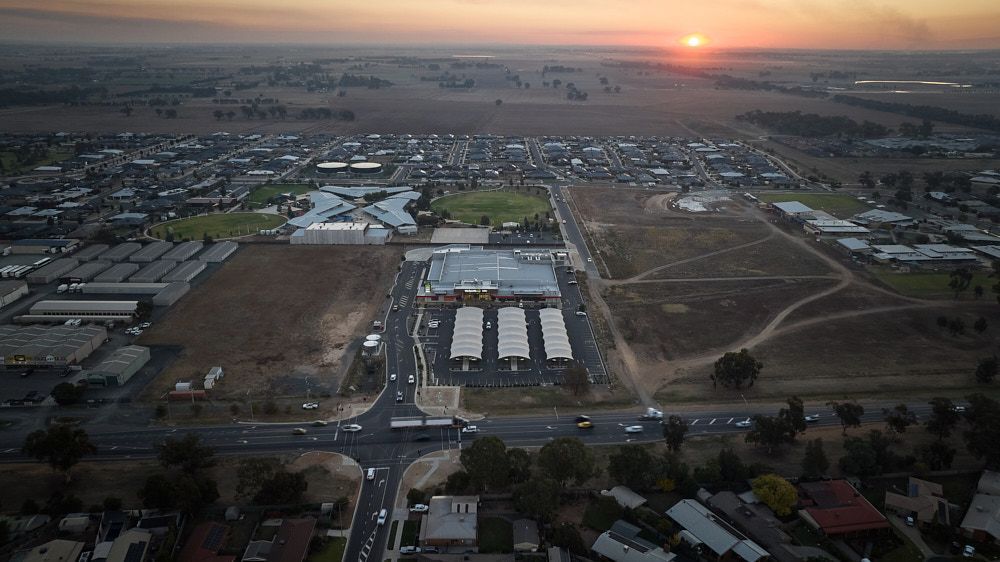 Aerial View at Sunrise of a Town With a Large Shopping Center — Quarrell Civil Construction In Congupna, VIC