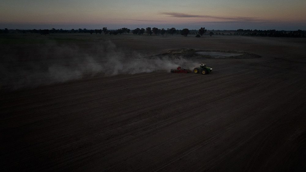 A Tractor Cultivates a Large, Dark Field at Dusk — Quarrell Civil Construction In Congupna, VIC